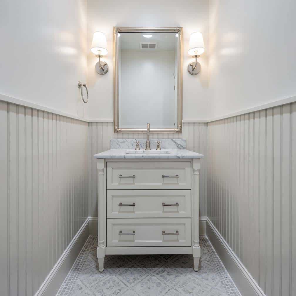 Narrow vertical wood strip panels with mosaic tile floor and marble countertop vanity