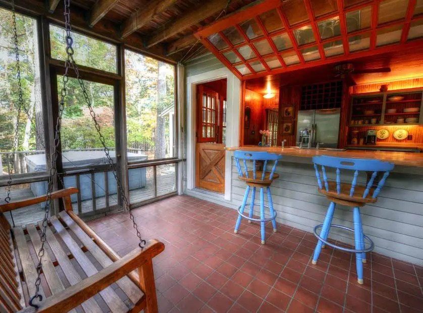 Kitchen with garage door style window bar and blue wood slat chairs