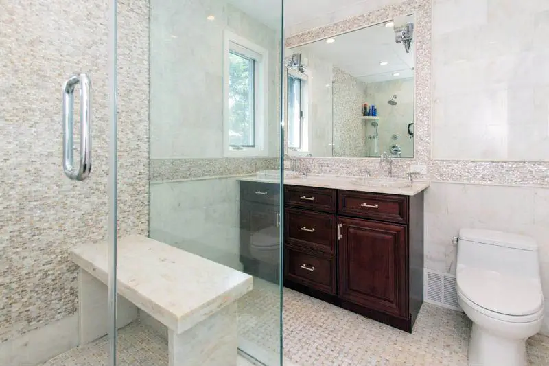 Shower with quartz bench and basketweave tile