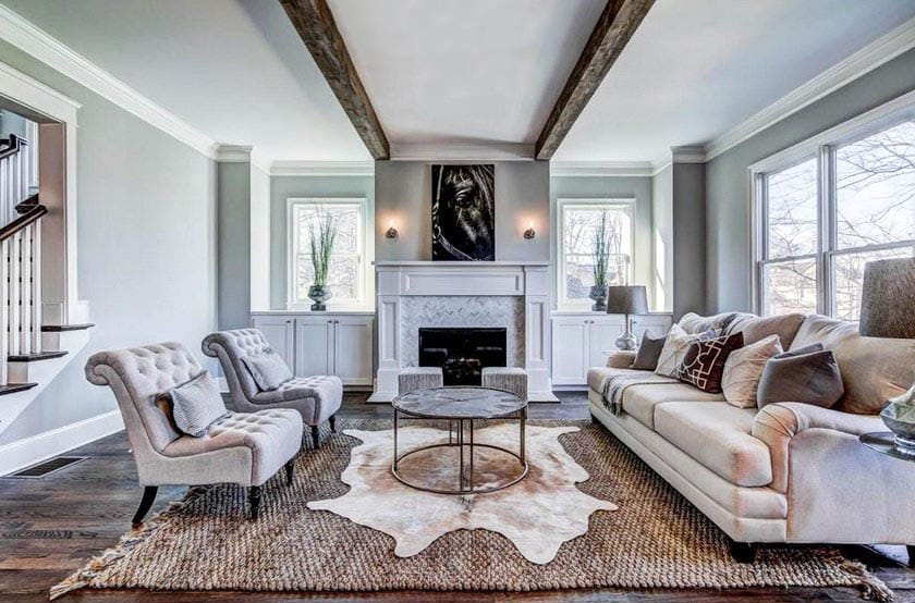 Traditional living room with faux wood ceiling wood flooring white mantle fireplace