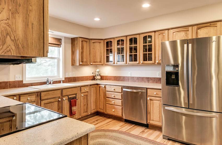 U shaped kitchen with hickory cabinets and hickory floors