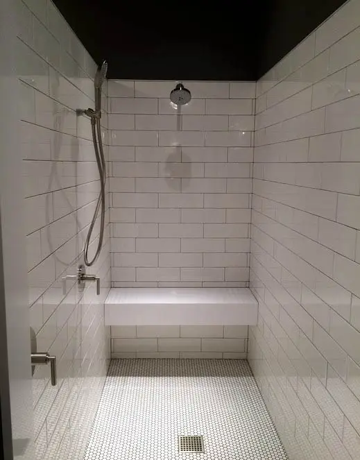 Subway tile bathroom with bench and shower