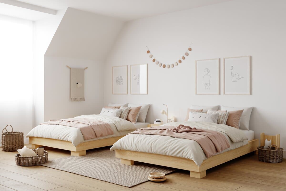Two low natural wood platform beds in a bright white Scandinavian room