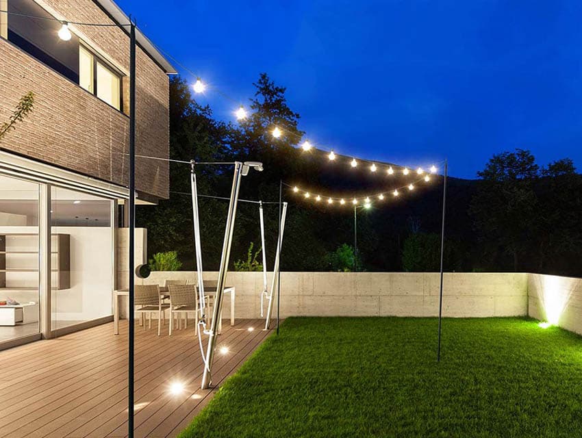 backyard deck with string light poles