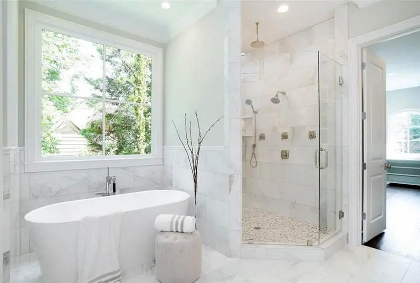 Bathroom with mosaic shower tiles and white freestanding tub