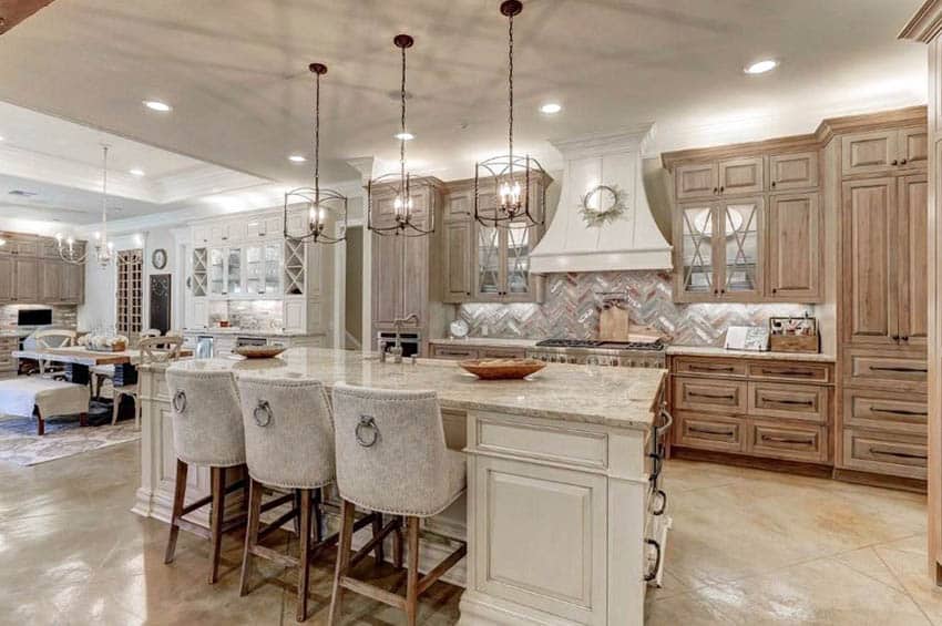 Kitchen with solid wood cabinets, cream island and beige marble countertops