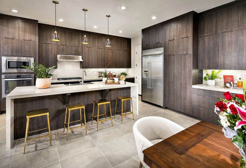 Porcelain floors, dark wood veneer cabinets and quartz counters