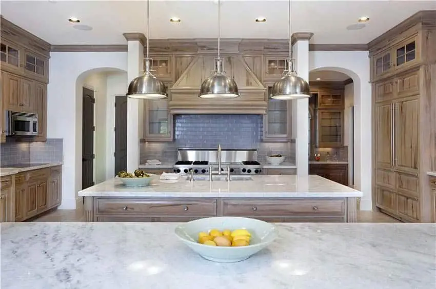 Kitchen with oak cabinets, white backsplash and under cabinet lighting