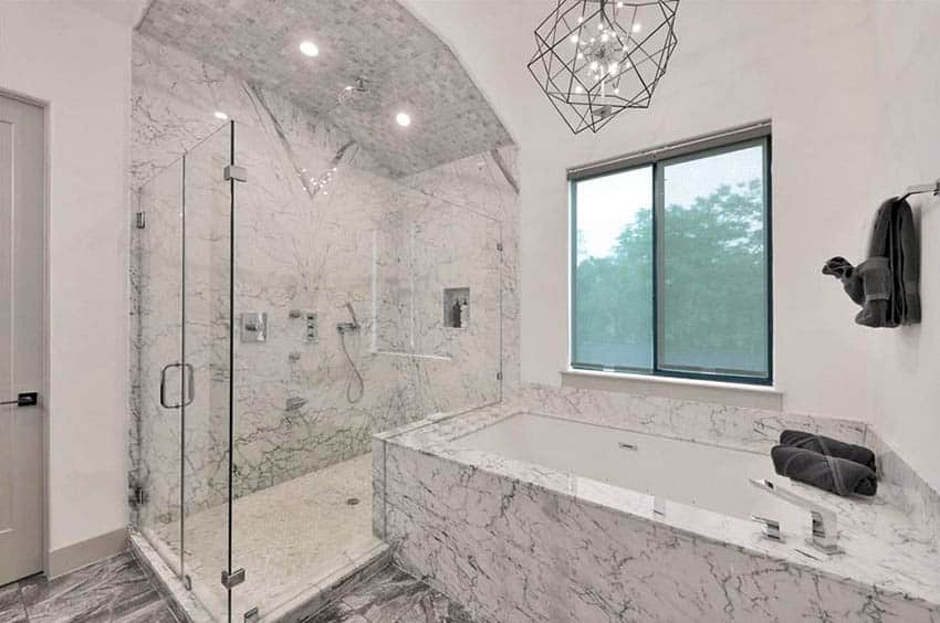 Custom walk in shower with arched tile ceiling and alcove tub