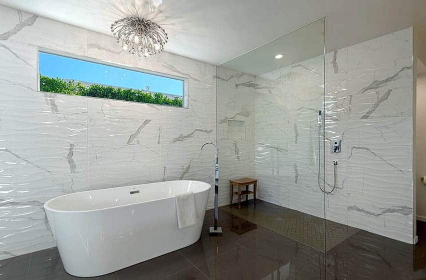 Custom walk in shower with no door wavy tile and freestanding tub