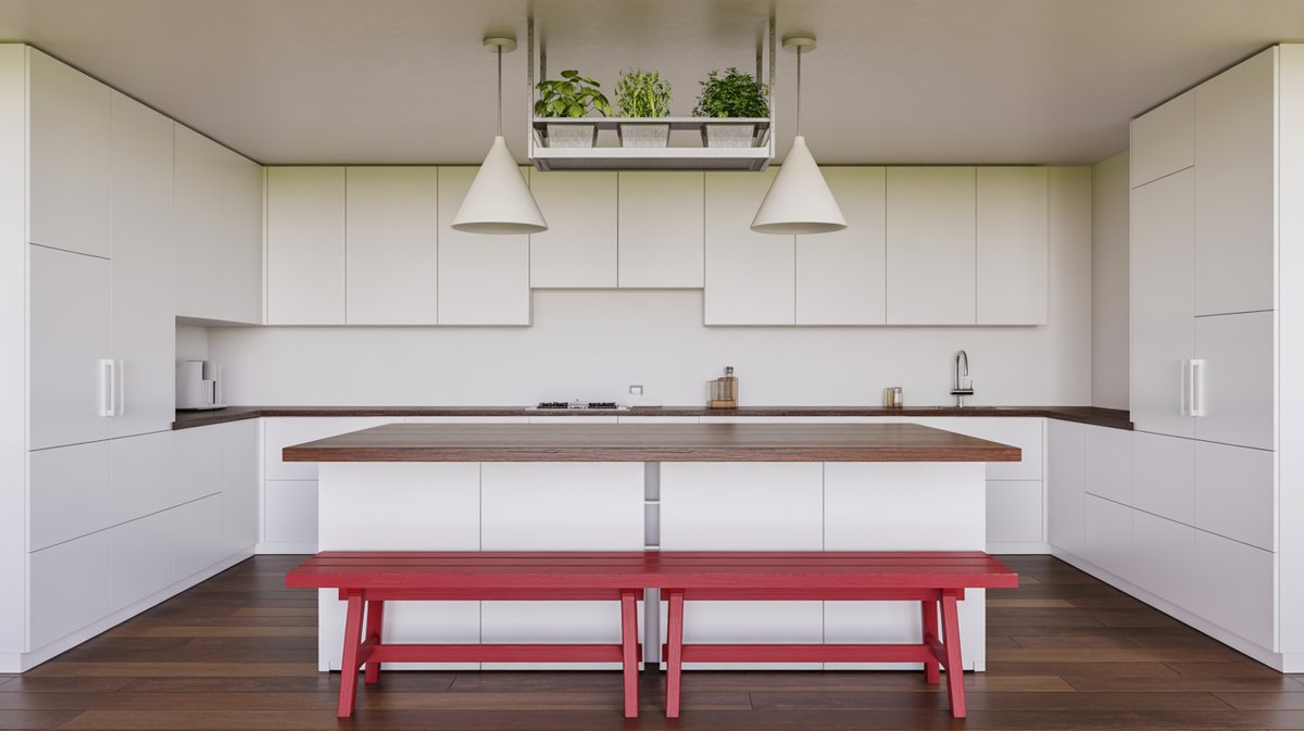 Minimalist white kitchen with wood butcher block island and two bright red painted benches for casual seating
