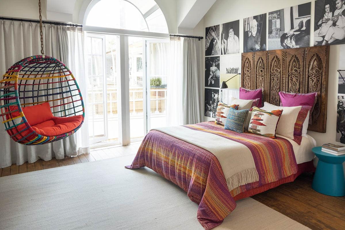 Fun teen bedroom with yarn hanging chair and photo accent wall