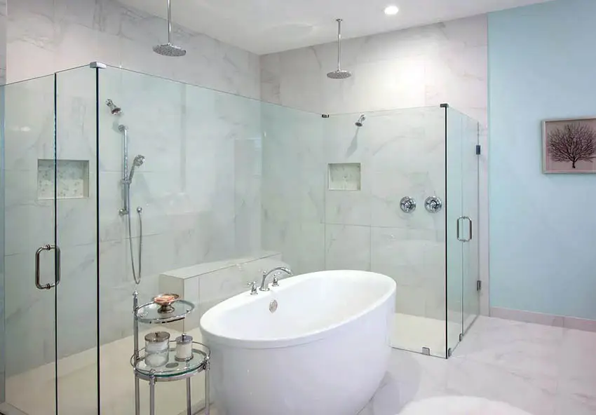 Two-door shower area, pale blue walls and tub