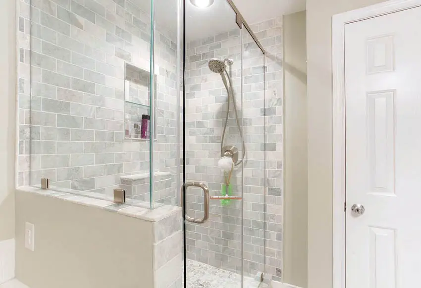 Closed panel door beside shower with horizontal tile placement