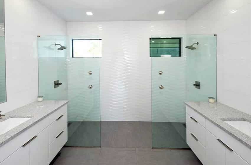 His and hers walk in shower with no door and glass partitions