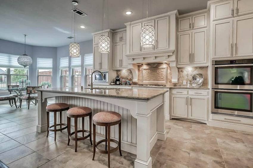 Kitchen with granite tile flooring and off white cabinets