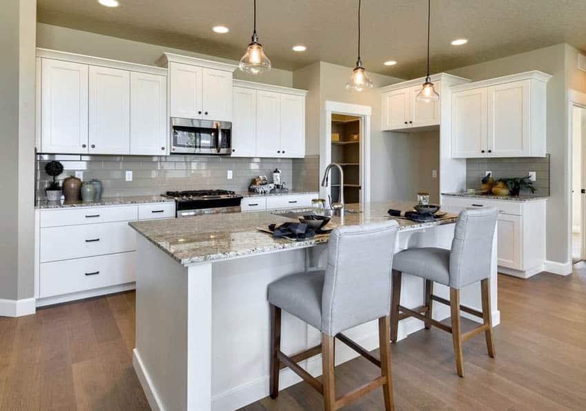 Kitchen with hardwood flooring, granite countertops and porcelain backsplash