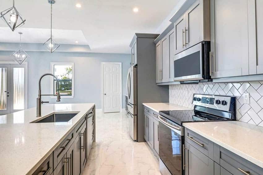 Kitchen with tile on the floor, and gray painted cabinets