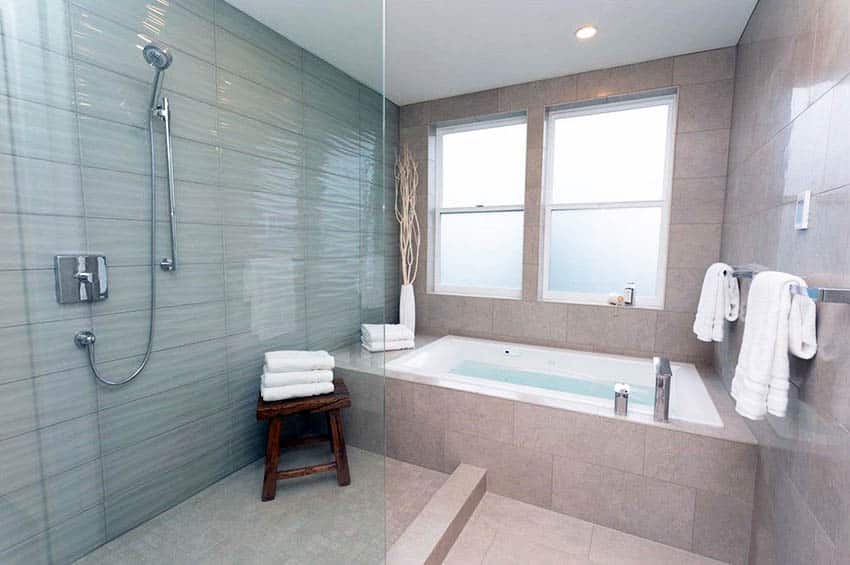 Large walk in shower with wavy porcelain tile and alcove tub