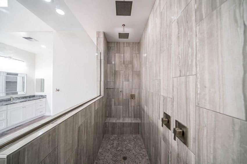 Long custom walk in shower with bench and dual rainfall shower heads