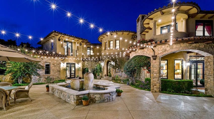 Luxury home with backyard string lights attached to walls