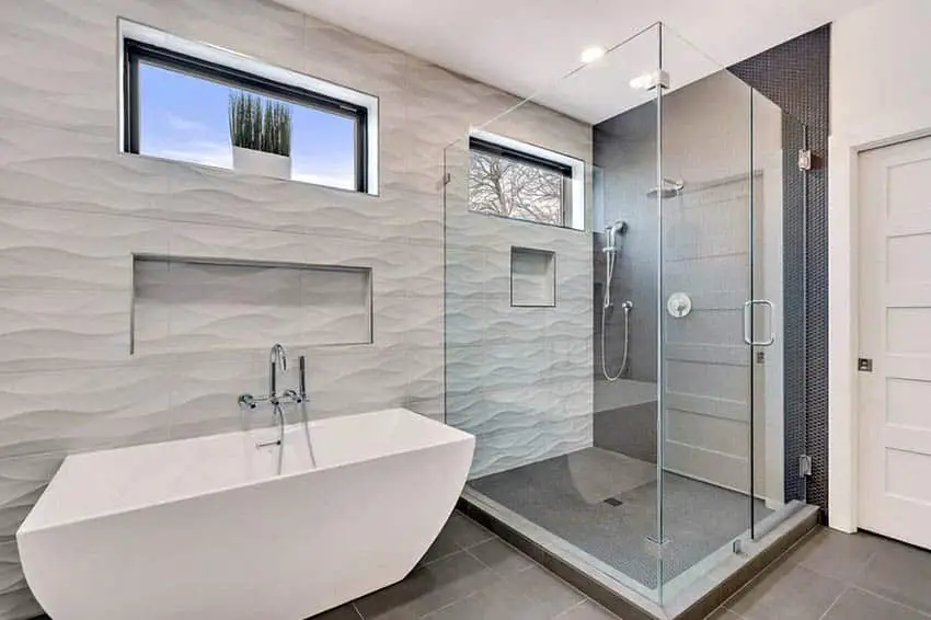 Taupe colored contoured walls in the bathroom with windows