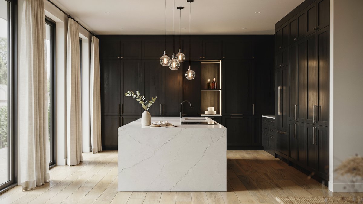 Dark lacquer MDF cabinets with a waterfall quartz countertop under a bulb chandelier