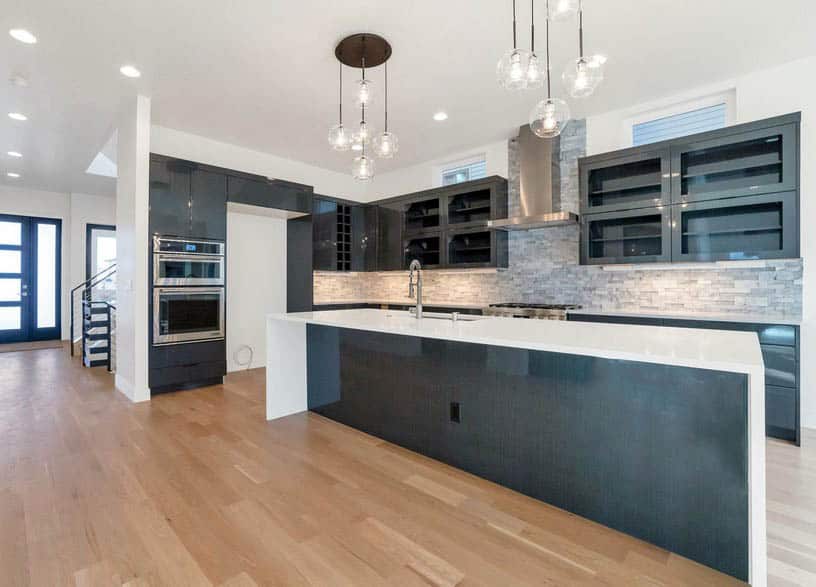 Modern kitchen with dark lacquer mdf cabinets and white quartz countertops