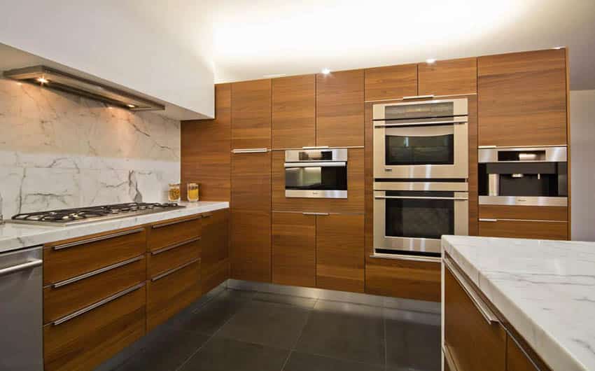 Modern kitchen with mdf cabinets stone backsplash and dark floor tile