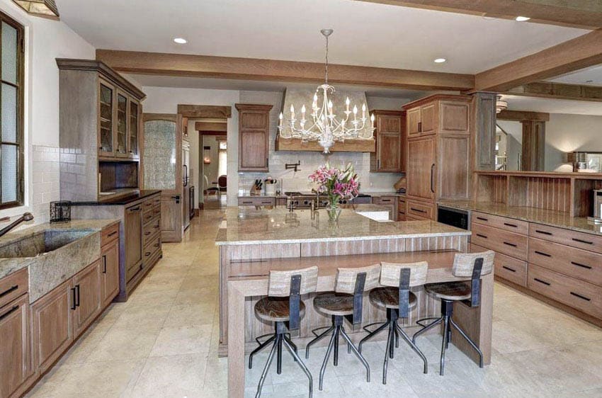 Open concept kitchen with solid wood cabinets breakfast bar and chandelier