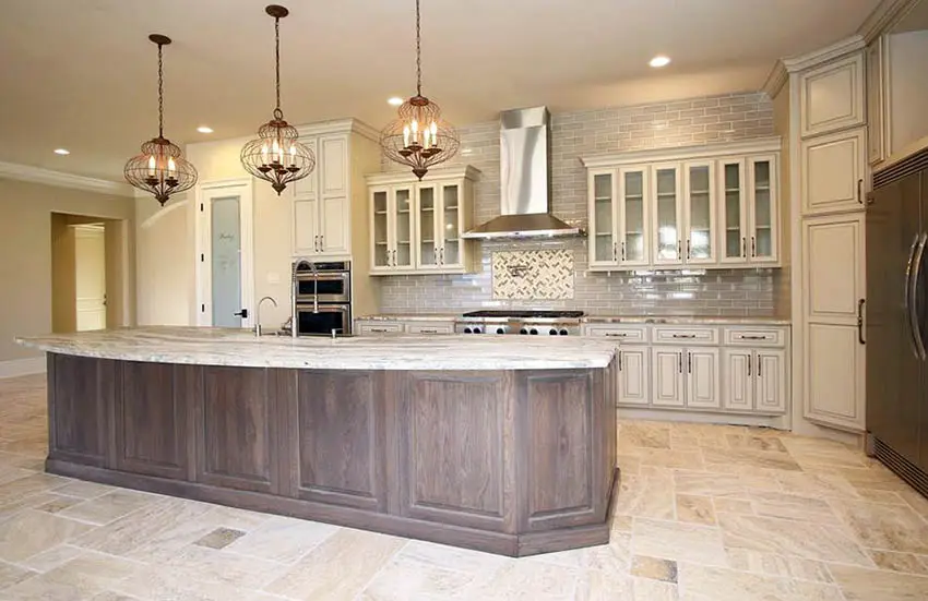 Open kitchen with travertine flooring, off white cupboards and wood island