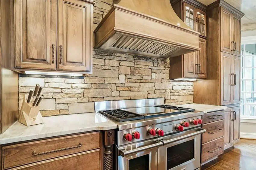 Kitchen with rough stone design backsplash, oak cabinets and wood flooring