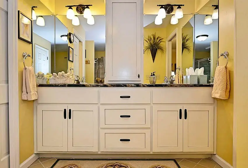 Small bathroom with bright yellow paint color and white vanity