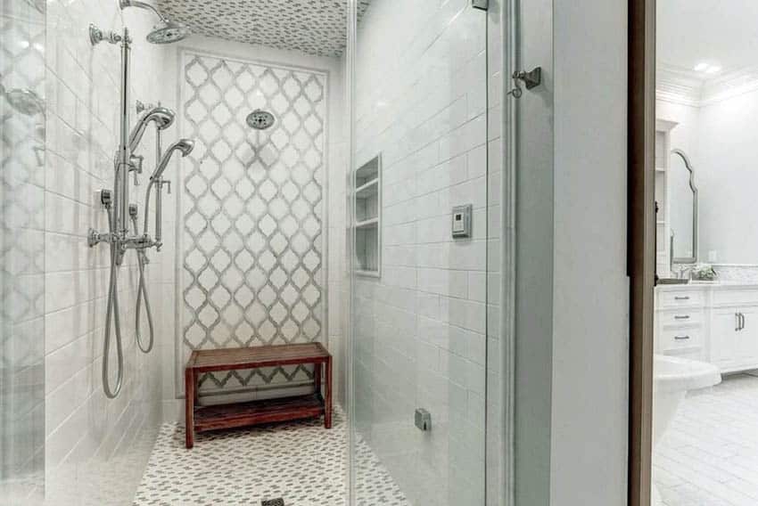 Small walk in shower with arabesque accent wall tile and rectangular white subway tile