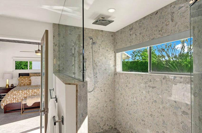 Shower area with stone material and white ceiling