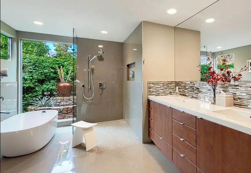 Bathroom with frameless mirror, brown tile backsplash and white stool