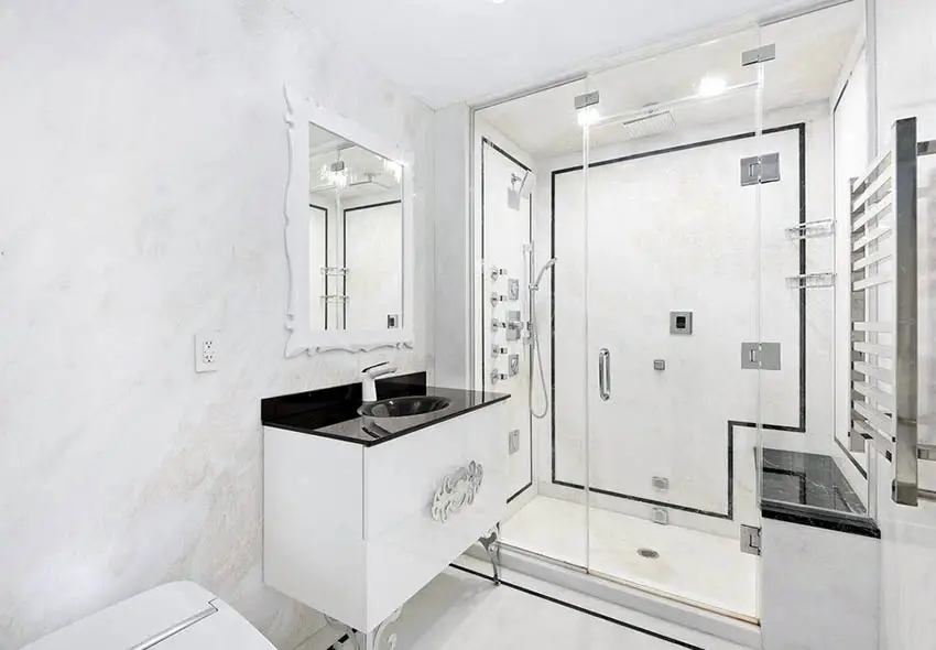 Walk in shower with white marble walls with stainless steel rack