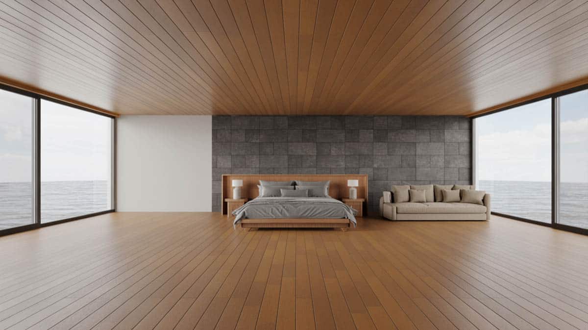 Industrial master bedroom with warm Brazilian cherry floors and exposed concrete walls and ceiling