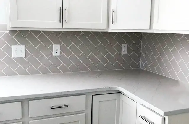 Kitchen with diagonal tiles and white outlet sockets