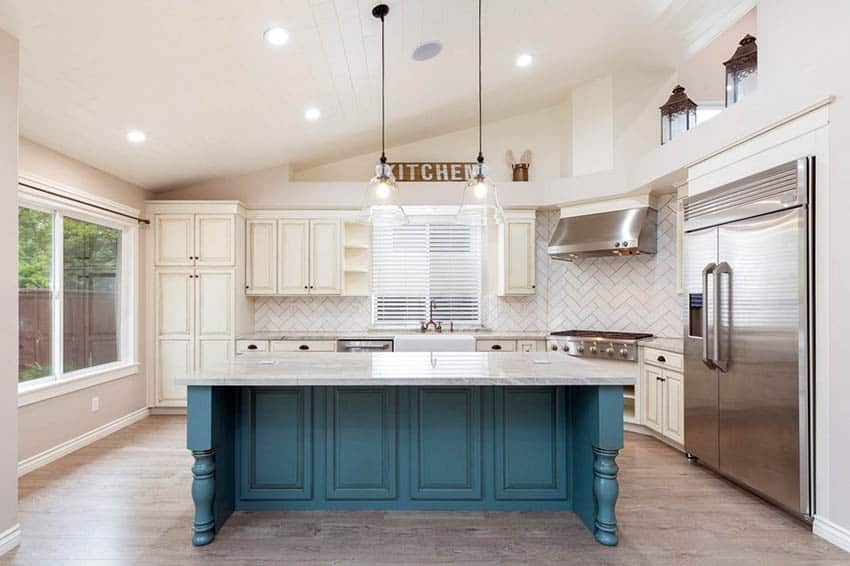 Kitchen with wall sign, herringbone pattern tile, cream cabinets and aqua blue island