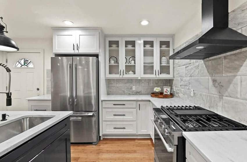 Kitchen with large marble tiles, stainless steel sink and recessed lighting