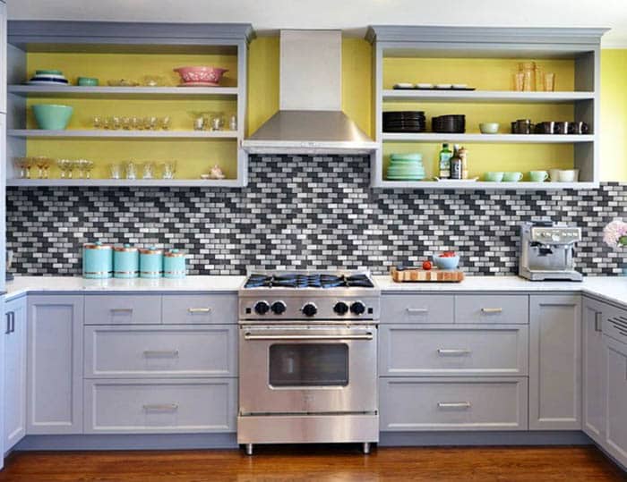 Kitchen with mosaic tiles and open shelving with yellow walls