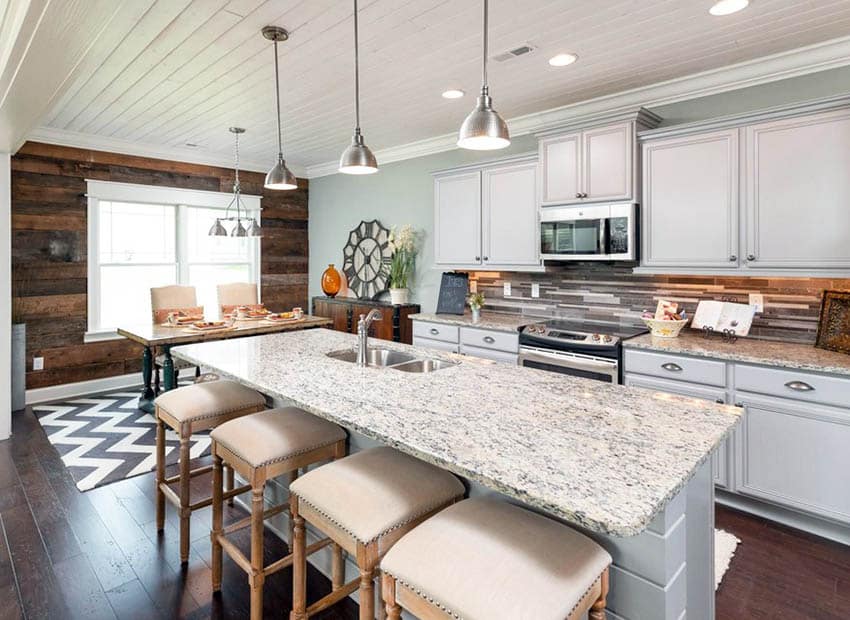 Kitchen with white washed tongue and groove planks and wood accent wall