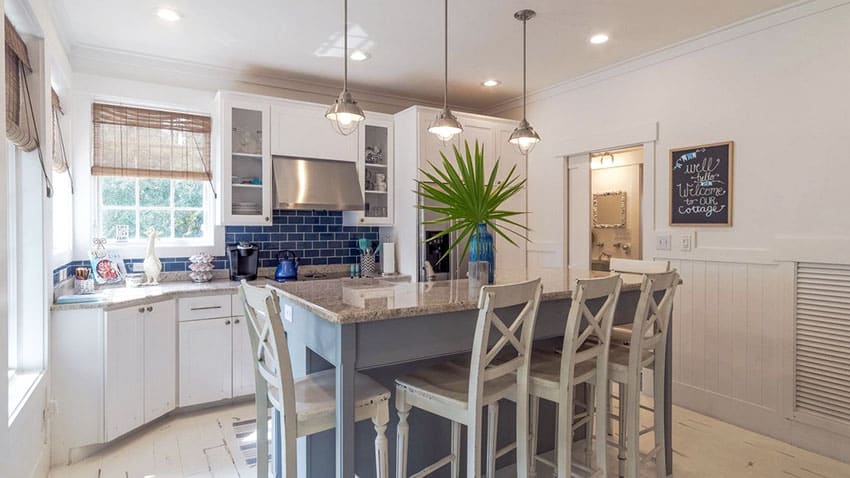 Kitchen with shiplap panel wainscoting and white and glass door cabinets