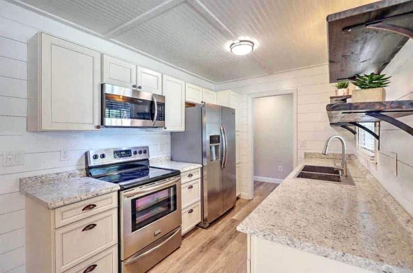 Galley kitchen with walls and ceiling made of shiplap 