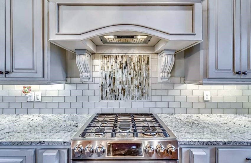 Kitchen with subway tile backsplash with gray grout and antique cabinets