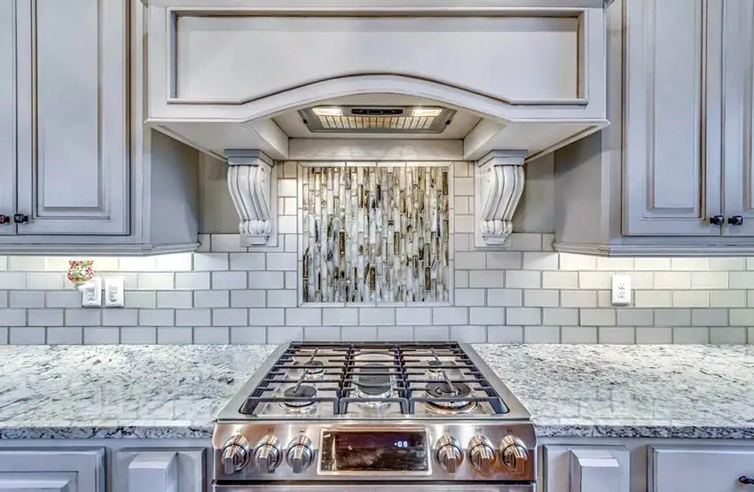 Kitchen with detailed paneling and accent tiles