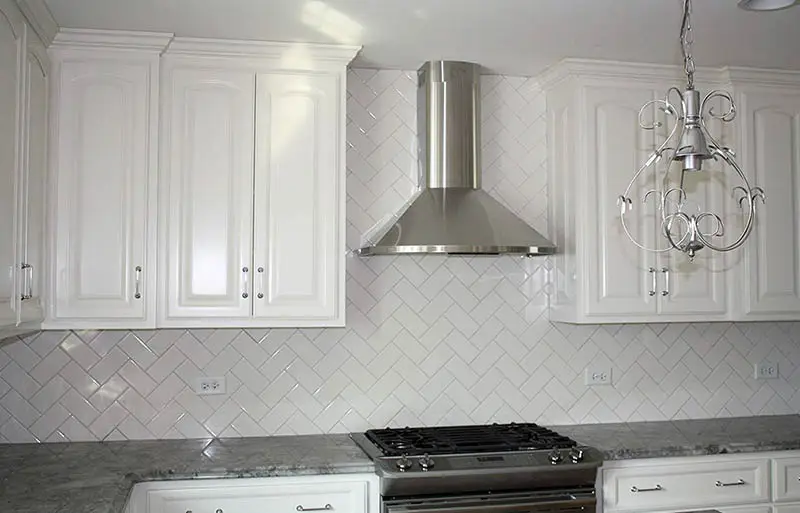 Kitchen with ceramic tiles and decorative chandelier