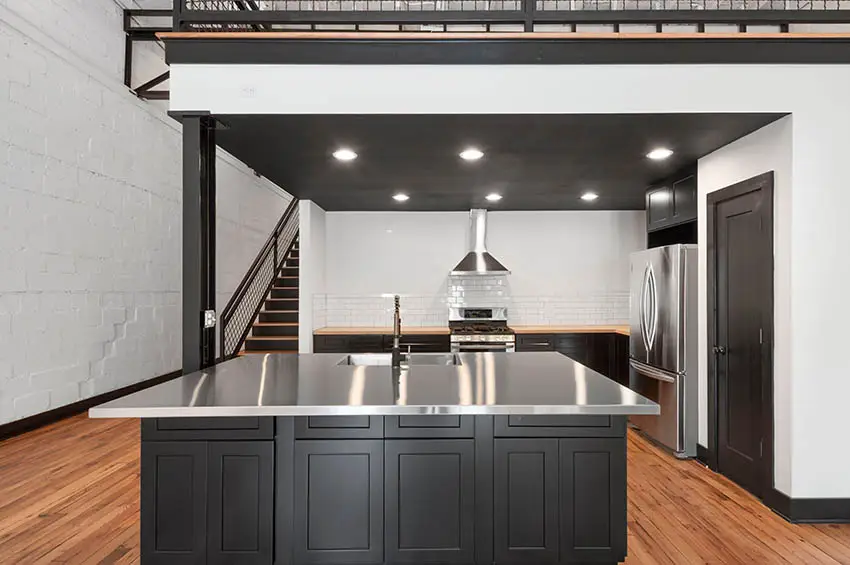 Kitchen with dark wood cabinets and white subway tile backsplash