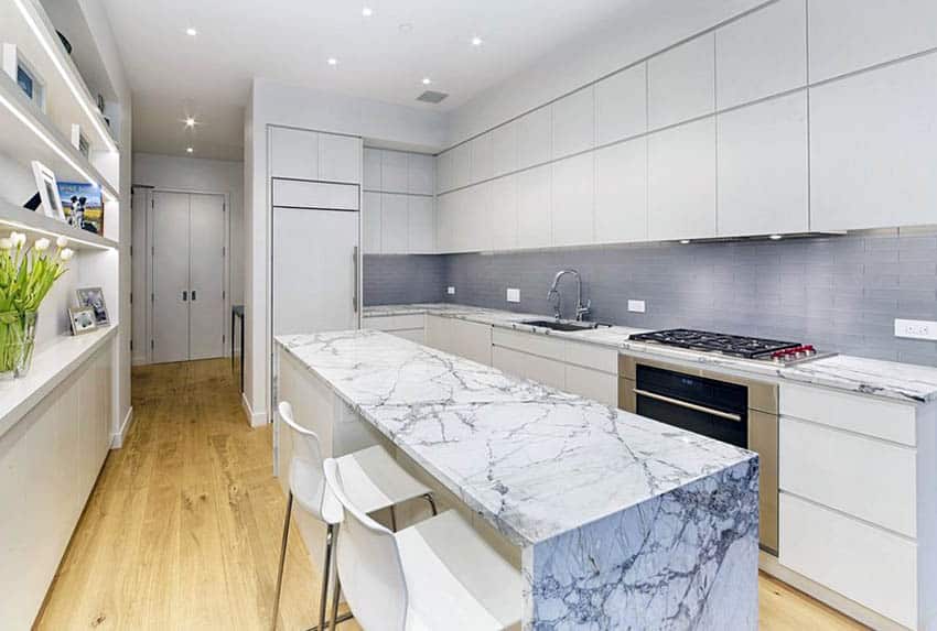 Modern kitchen with gray subway tile backsplash white cabinets